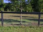 Horseman Mesh Fencing with a black top site rail