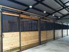 Multiple Welded horse stalls with grill top door sliding door and feed door