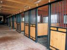 Angled view of multiple nobleman stall fronts with their doors open