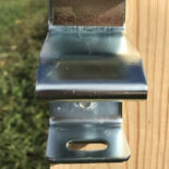 close-up of silver latch catch for 1-way locking latch