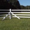 a photo of the corner of a white 4 rail fence
