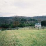 wooden board fence in a large field