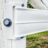 closeup of end plate attached to white post