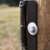 extreme closeup from above a a brown end plate attached to a wood post