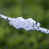 a strand of white and black braided electric fence joined with a white connector