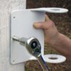 wrench driving lag bolt to attach tightener plate to post