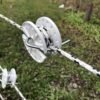 tightener holding white and black braided rope