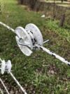tightener holding white and black braided rope