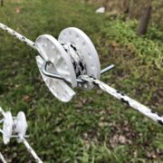 tightener holding white and black braided rope