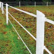 3 strands of white electric tape installed on white wooden posts