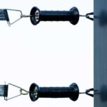 2 black electric gate handles connected to 2 rails of electric tape