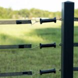 3 black electric gate handles connected to 3 rails of electric tape