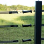3 black electric gate handles connected to 3 rails of electric tape