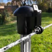 a single strand of white and black braided electric fence installed on top of a metal post