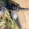 connector attached to wire on fence post