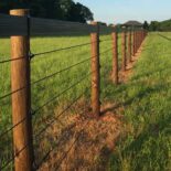 shockline electric fence with a brown vinyl fence top rail installed on brown fence posts