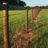 shockline electric fence with a brown vinyl fence top rail installed on brown fence posts