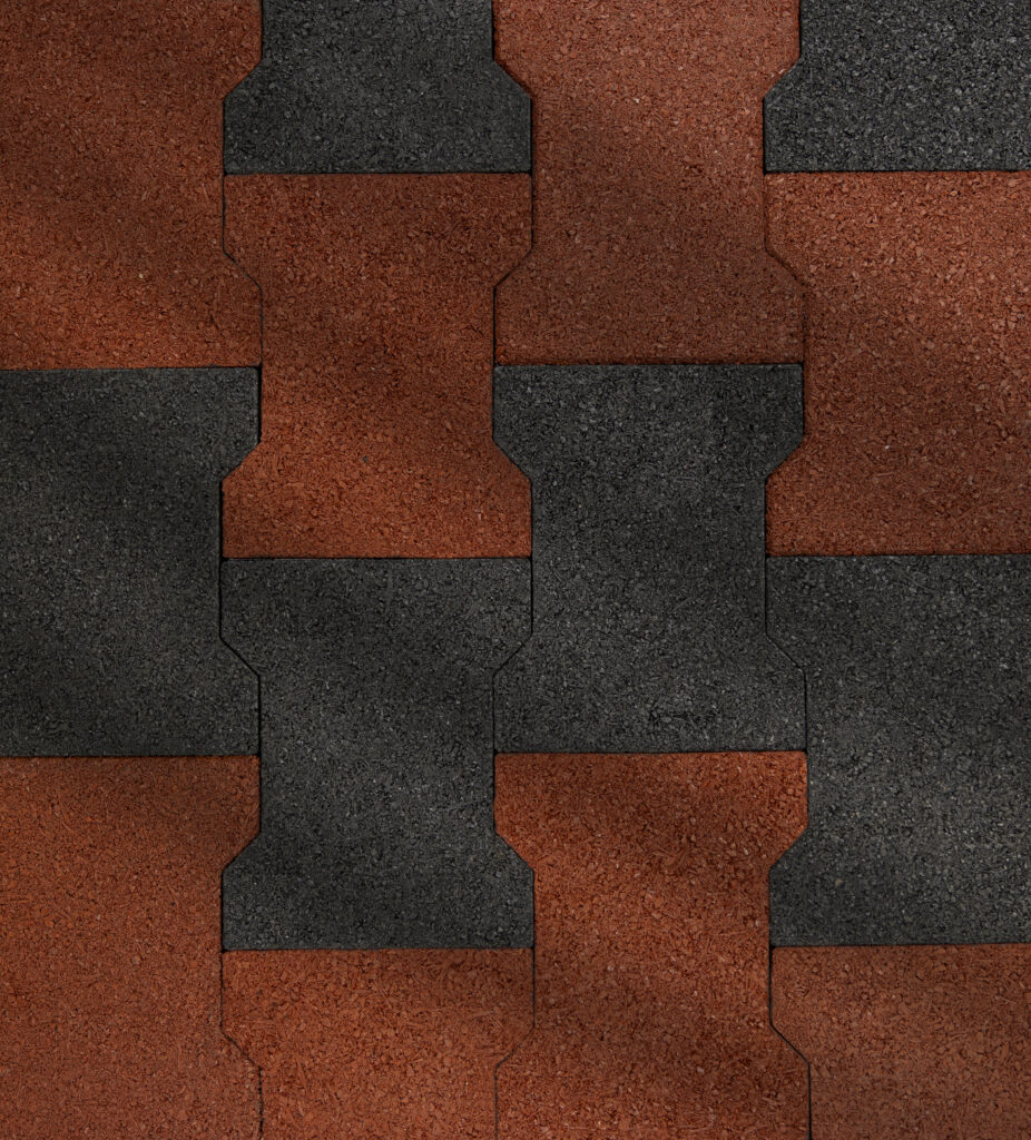 closeup of terra-cotta and black rubber pavers laid out in an alternating pattern